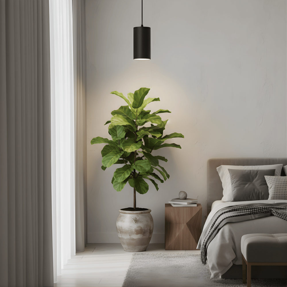 Modern bedroom with a potted plant and black pendant grow light, bed, and side table.