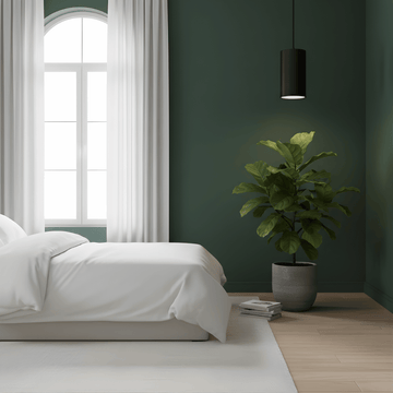 Modern bedroom with green walls, white bedding, and a potted plant and pendant grow light.