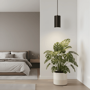 Modern bedroom with a bed, nightstand, potted plant and black pendant grow light.