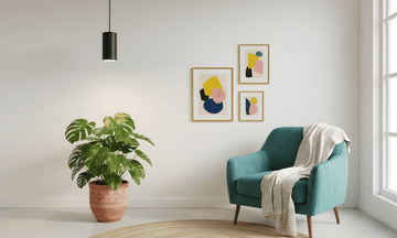 Modern living room with teal armchair, plant and black pendant grow light, and abstract art on the wall.