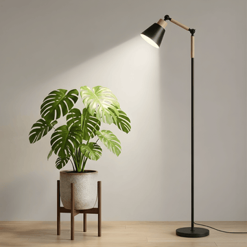 Floor grow light with a plant on a wooden stand against a neutral background