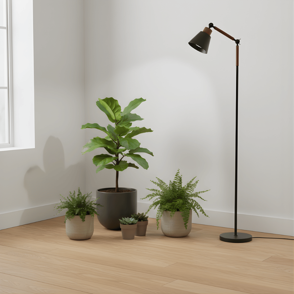 Potted plants and a floor grow light in a room with a window.