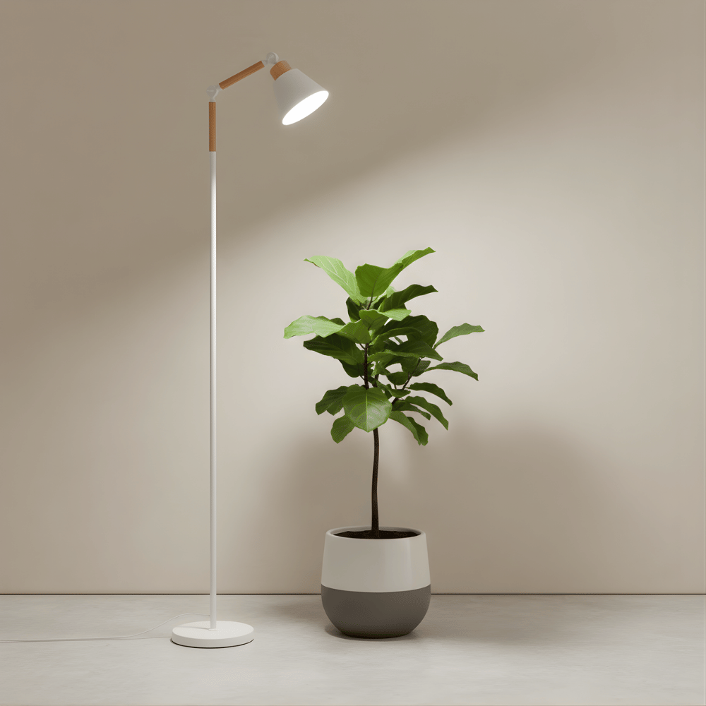 Modern floor grow light with a white light bulb next to a potted plant on a neutral background