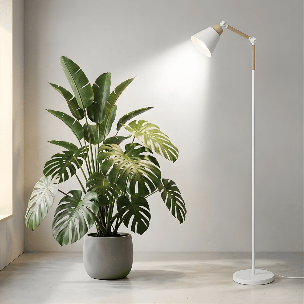 Potted plant and standing grow light in a room with a neutral background